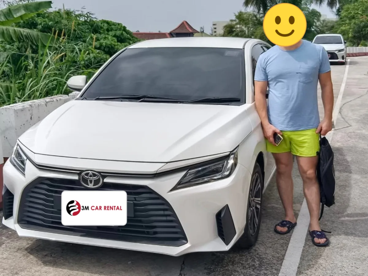 Guest with a white Toyota rental car on the Phuket roadside