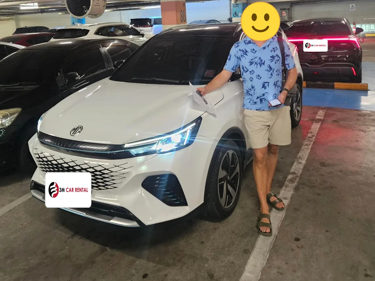 Guest taking delivery of a white MG rental car