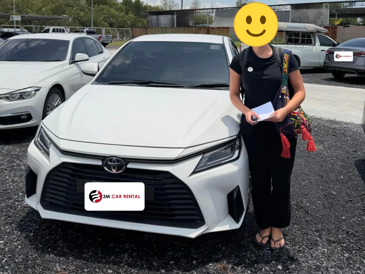 Guest receiving her white Toyota Yaris Ativ rental car in Phuket